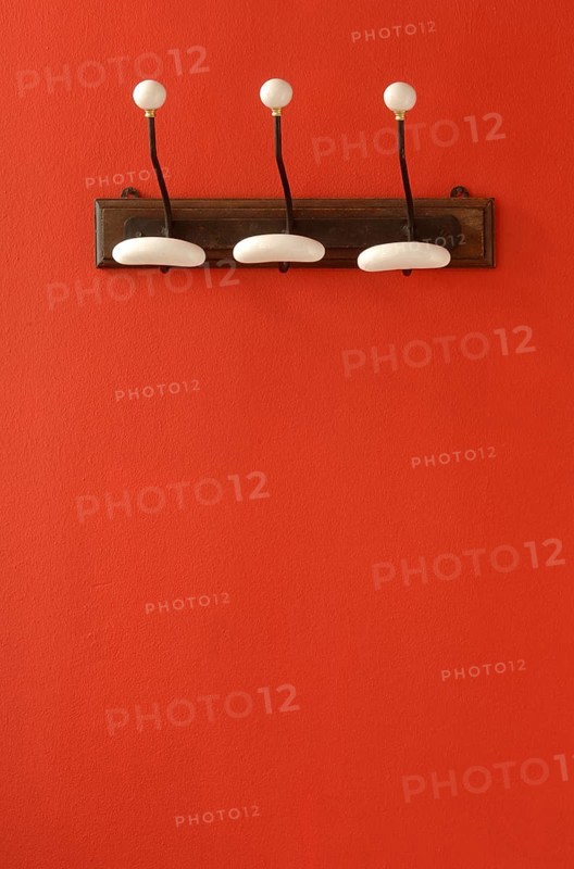 Nostalgic coat hooks on red wall