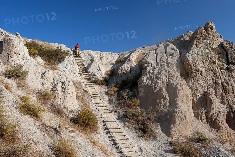 Man climbing a ladder in the Badlands