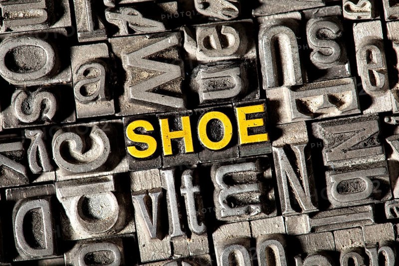 Old lead letters forming the word 'SHOE'