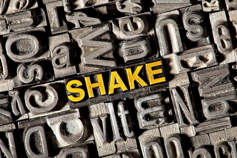 Old lead letters forming the word 'SHAKE'