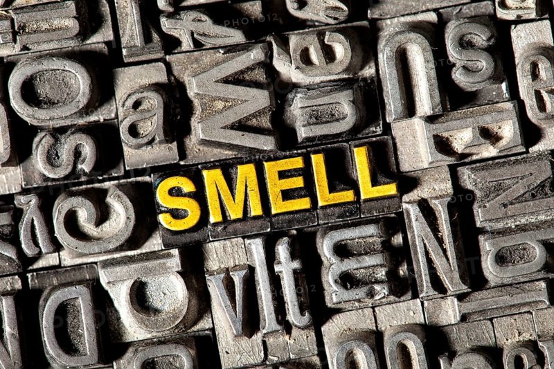 Old lead letters forming the word 'SMELL'