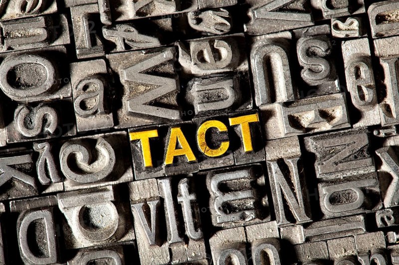 Old lead letters forming the word 'TACT'