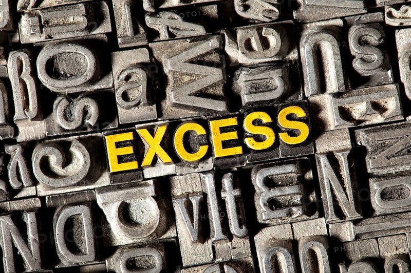 Old lead letters forming the word Excess