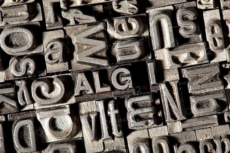 Old lead letters forming the word 'ALG I'