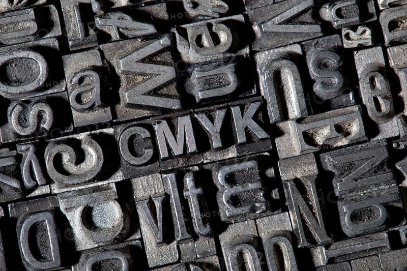 Old lead letters forming the term CMYK