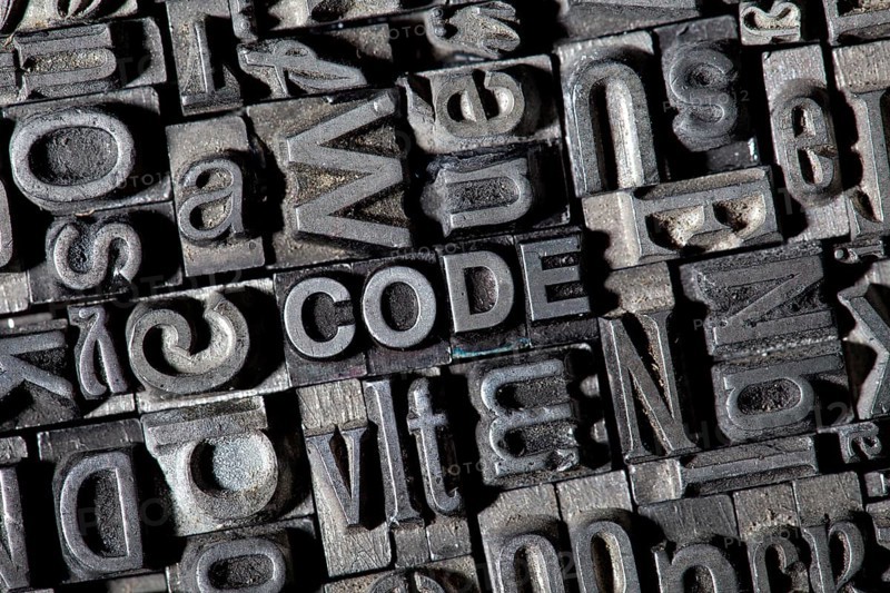 Old lead letters forming the word CODE