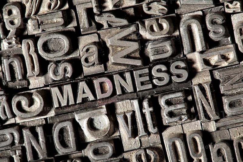 Old lead letters forming the word "MADNESS"