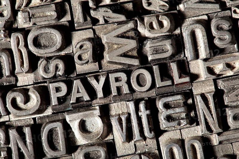 Old lead letters forming the word 'PAYROLL'