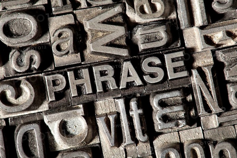 Old lead letters forming the word "PHRASE"