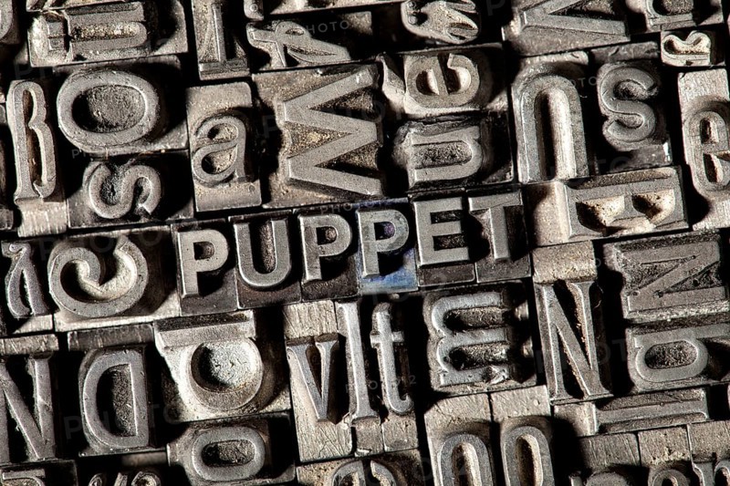 Old lead letters forming the word 'PUPPET'
