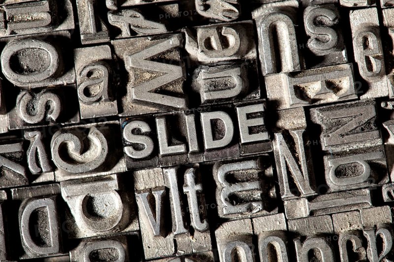 Old lead letters forming the word SLIDE