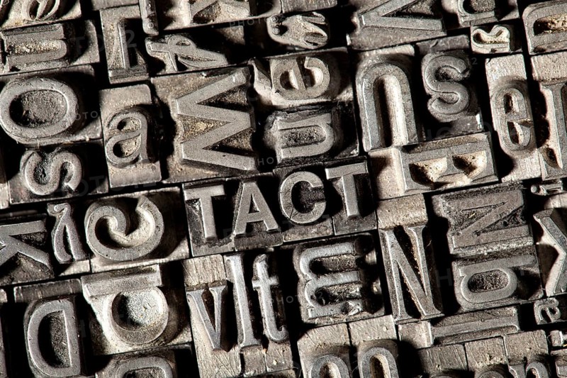Old lead letters forming the word TACT