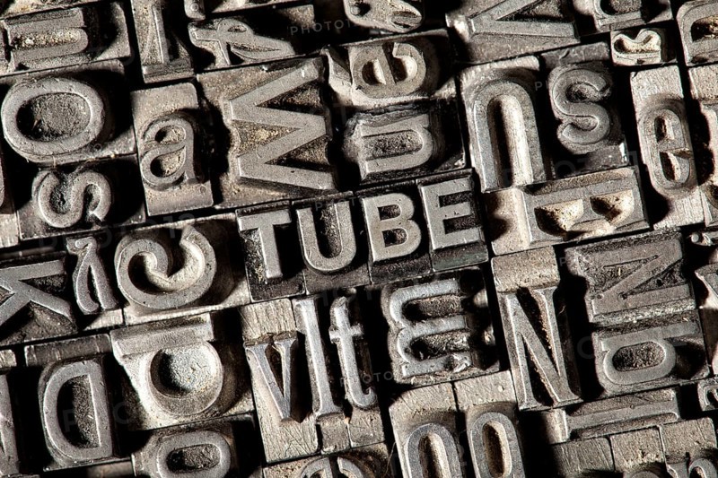 Old lead letters forming the word TUBE