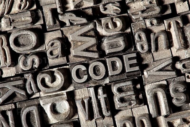 Old lead letters forming the word CODE