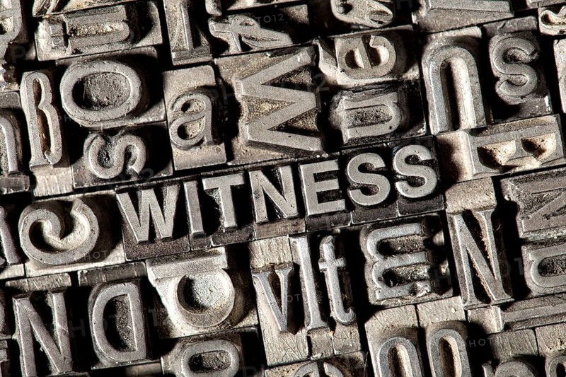 Old lead letters forming the word WITNESS