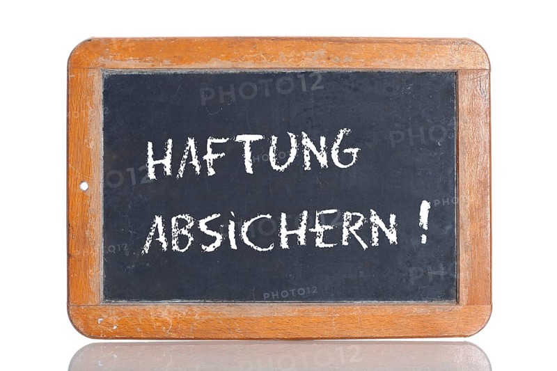 Old school blackboard with the words HAFTUNG ABSICHERN!