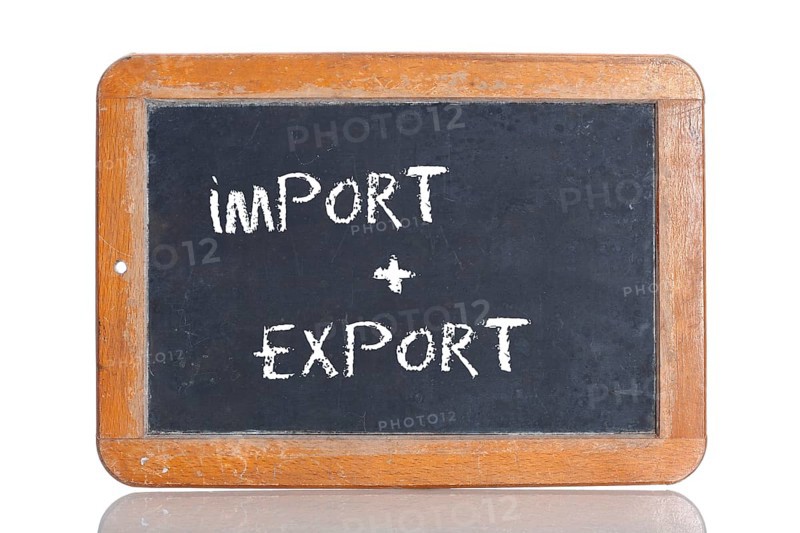 Old school blackboard with the words IMPORT + EXPORT