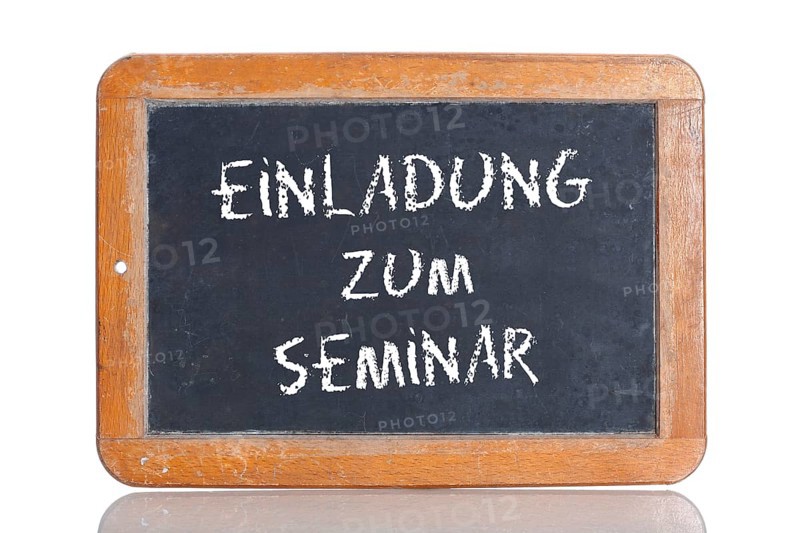 Old school blackboard with the words EINLADUNG ZUM SEMINAR