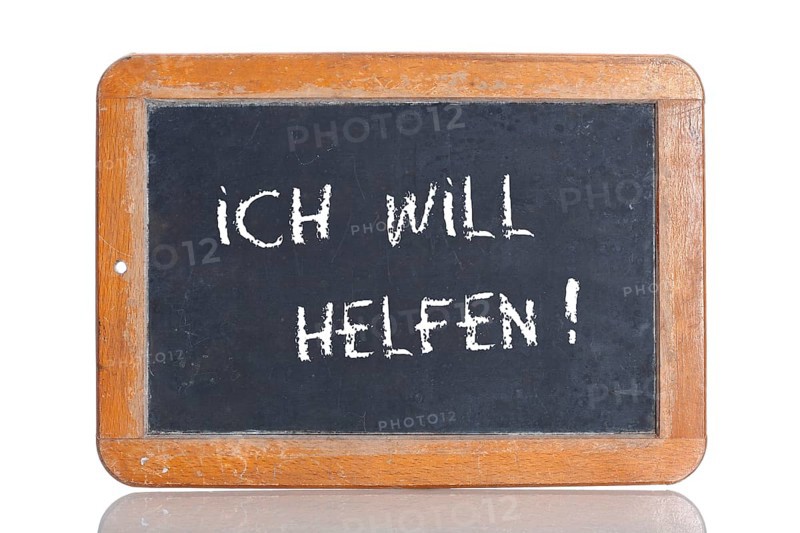 Old school blackboard with the words ICH WILL HELFEN!