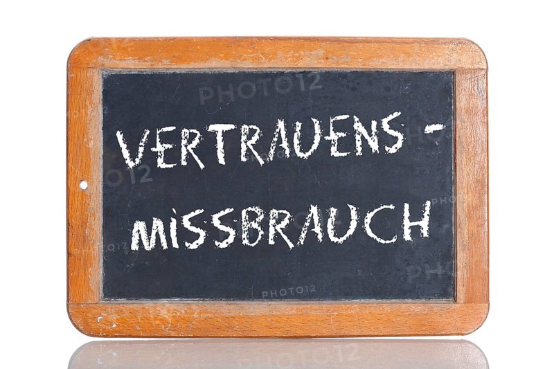 Old school blackboard with the term VERTRAUENSMISSBRAUCH