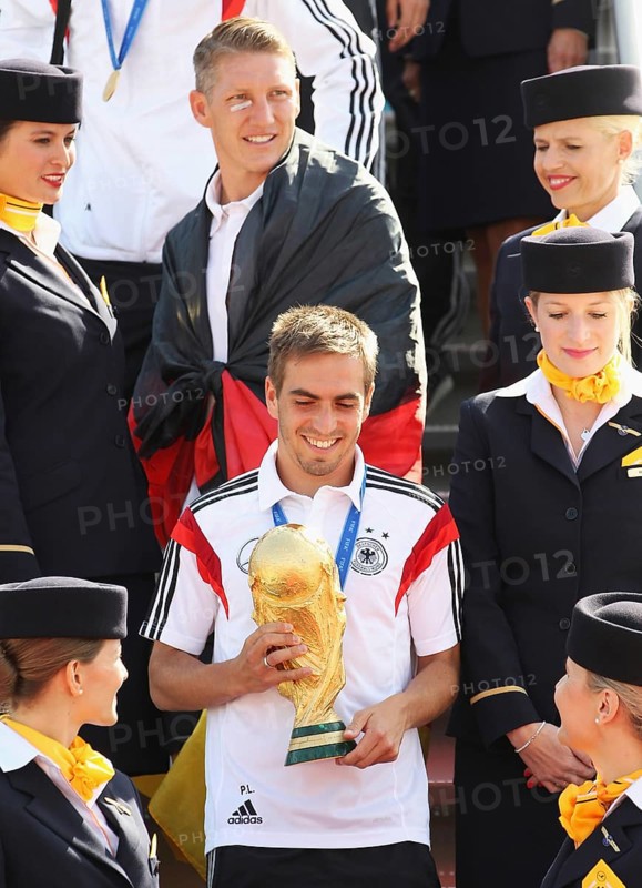 Philipp Lahm with the trophy and Bastian Schweinsteiger