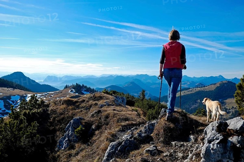Female mountain hiker with Labrador