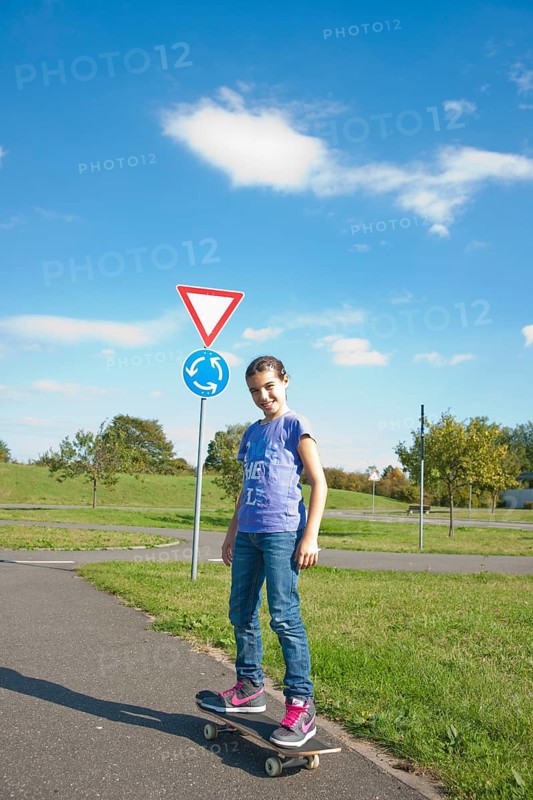 Girl riding a skateboard on a street