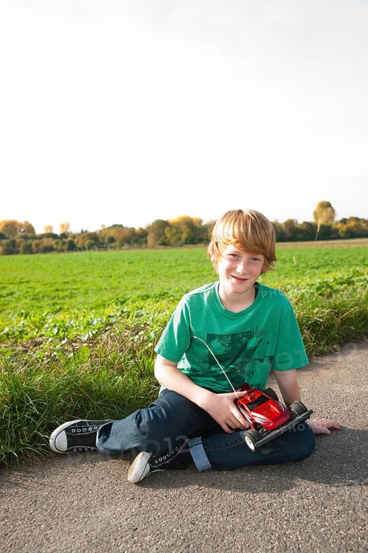 Boy playing with his radio-controlled model car
