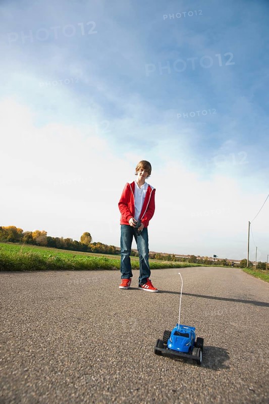 Boy playing with his radio-controlled model car