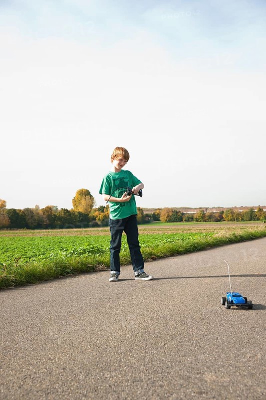 Boy playing with his radio-controlled model car