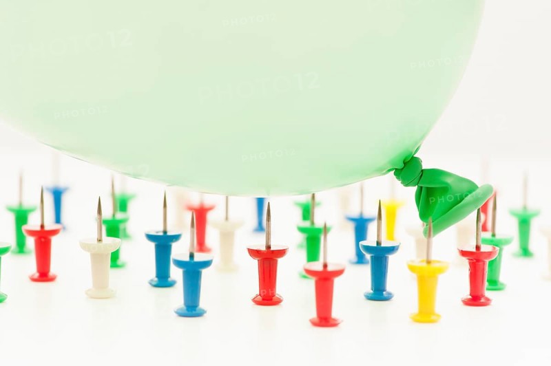 Balloon falling on pins