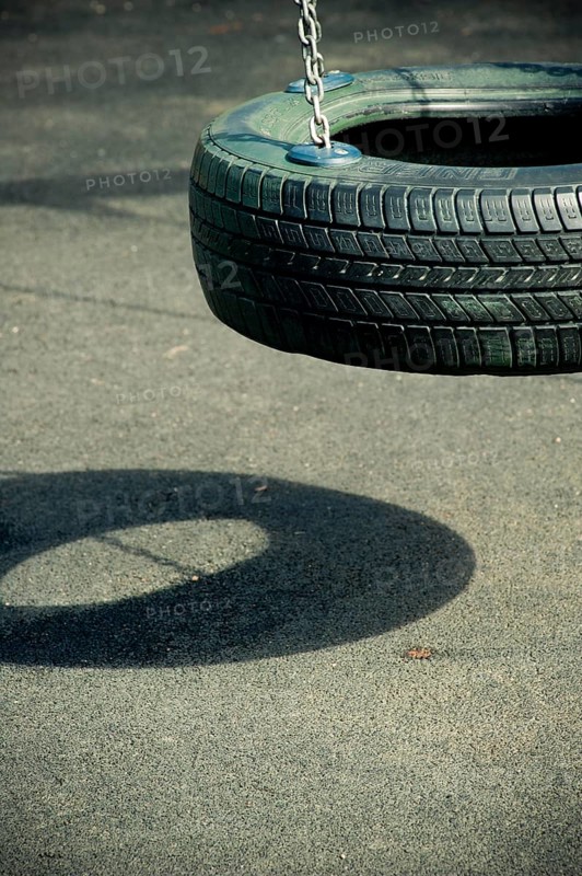 Empty swing made from a tyre at playground