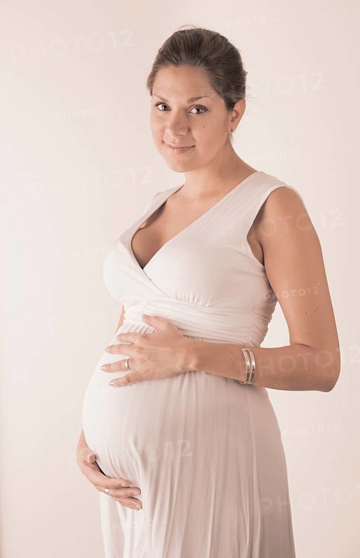 Pregnant woman holding hands on her stomach