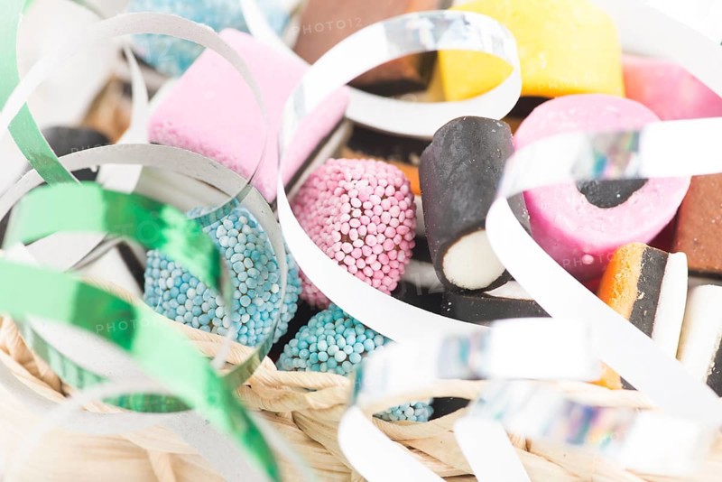 Small basket filled with liquorice candy and decorated with silver streamer