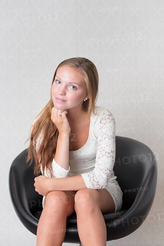 Young woman sitting in a vintage chair