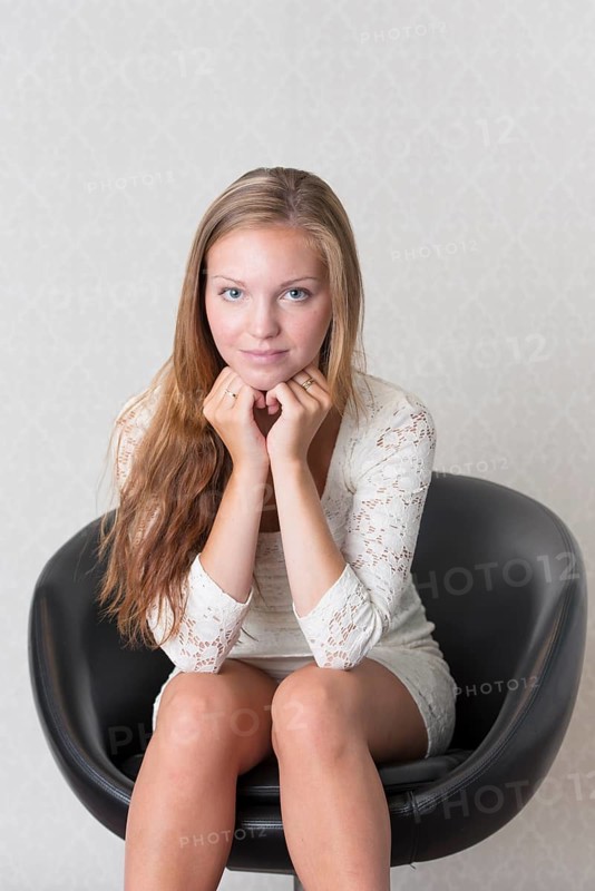 Young woman sitting in a vintage chair