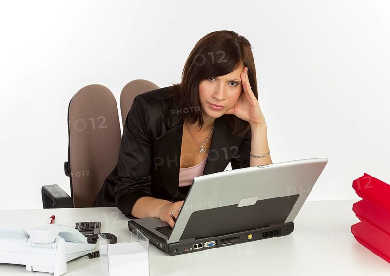 Young woman with a laptop sitting at a desk
