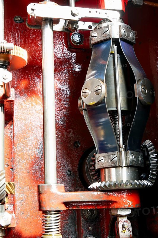 View into the open housing of a mechanical centrifugal governor for limiting the speed