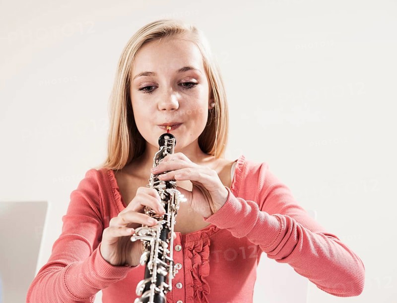 Teenage girl playing the oboe