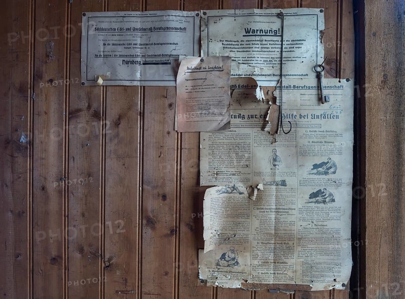 Information from the employers' liability insurance association on a wooden wall