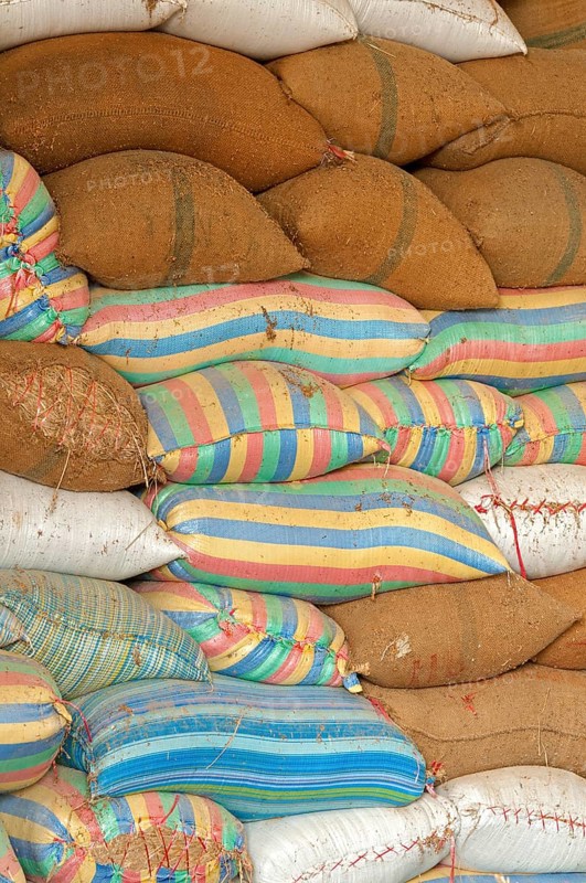 Plump bags of rice stacked in a rice warehouse