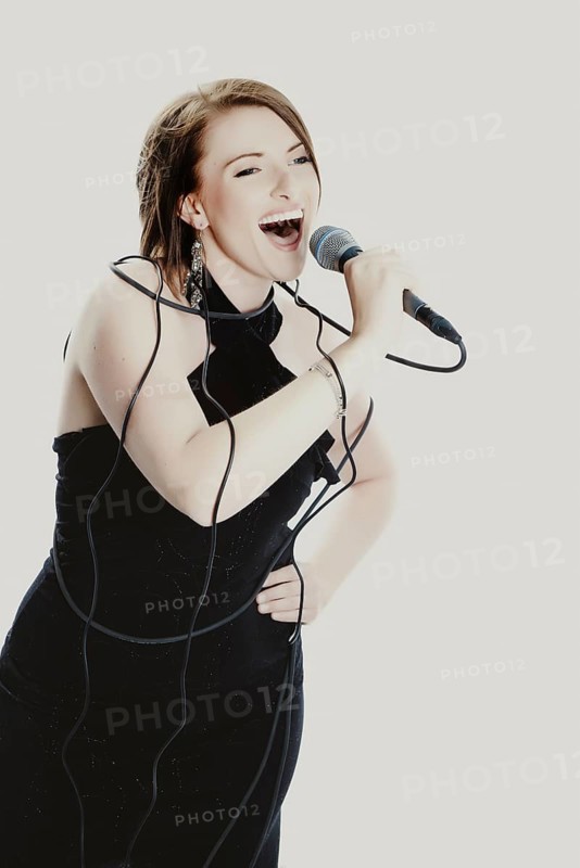 Woman singing into a microphone