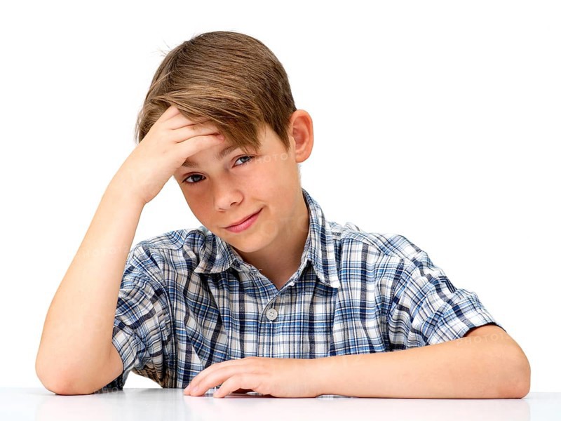 Boy with his hand supporting his head