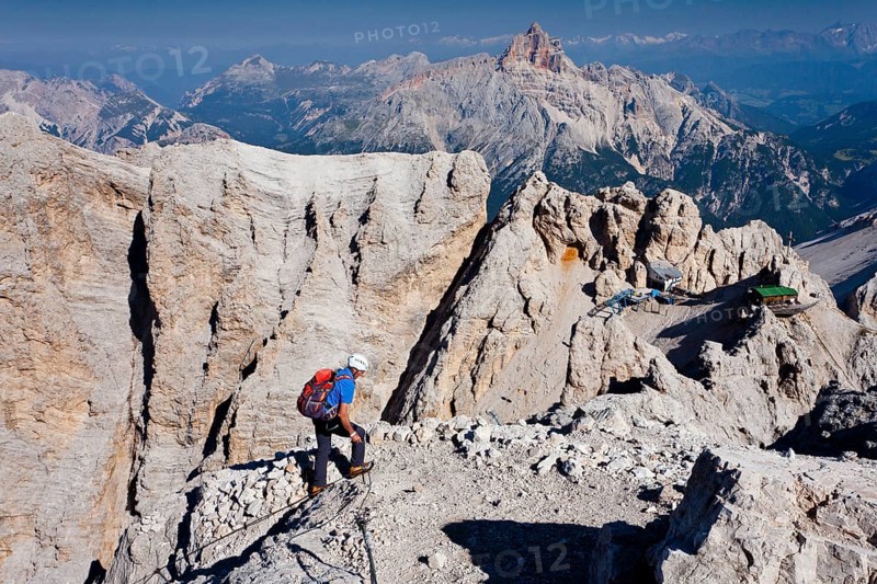 Mountaineer climbing the Via Ferrata Marino Bianchi climbing route on Monte Cristallo to the summit of Cristallino di Mezzo above Cortina