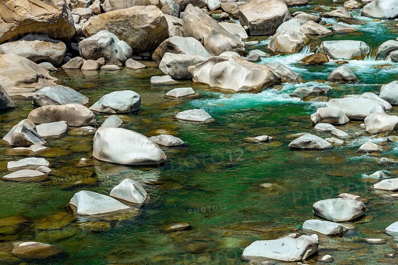 Stones in green clear water