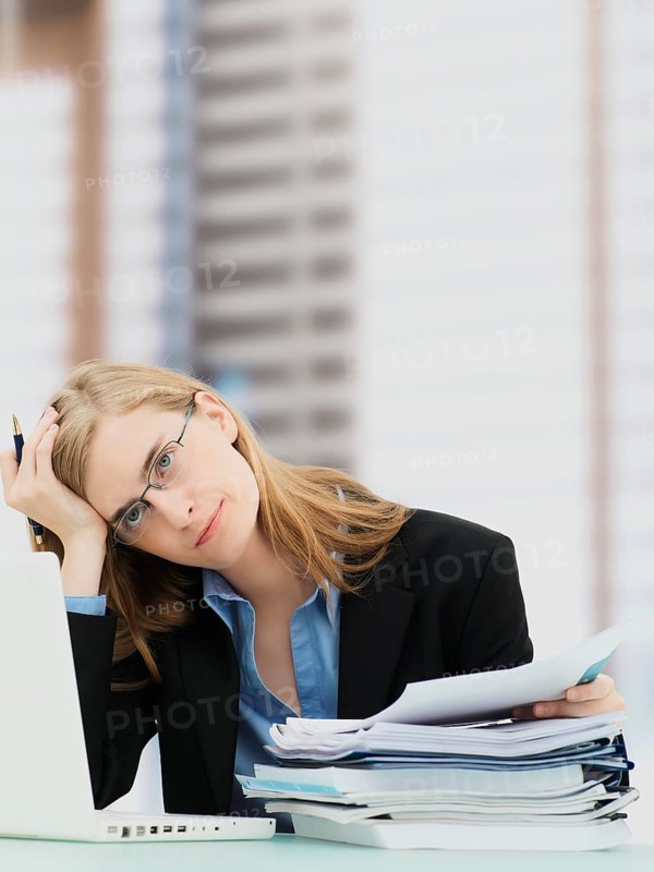 Businesswoman wearing glasses and using a laptop