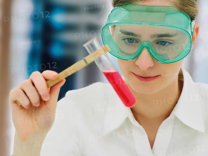 Scientist wearing a protective mask and holding a test tube