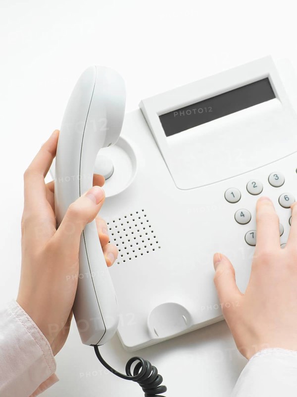 Woman making a call on a telephone