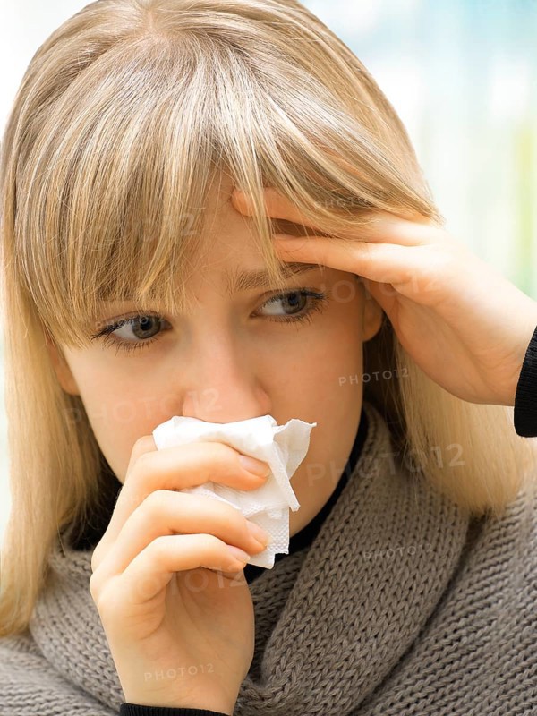 Young woman using a tissue