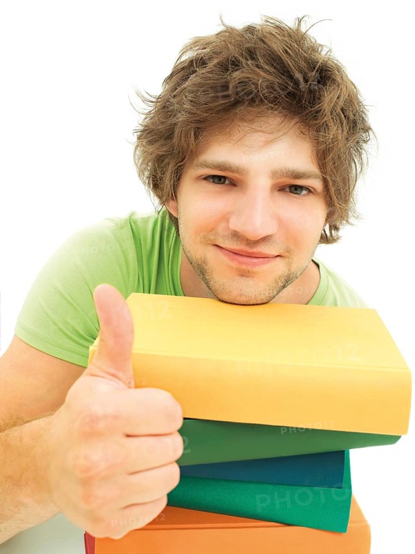 Young male student with a stack of books making a thumbs up gesture